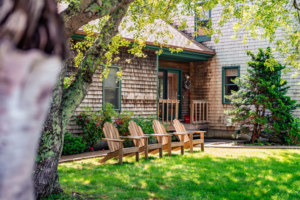 Adirondack chairs out front. 