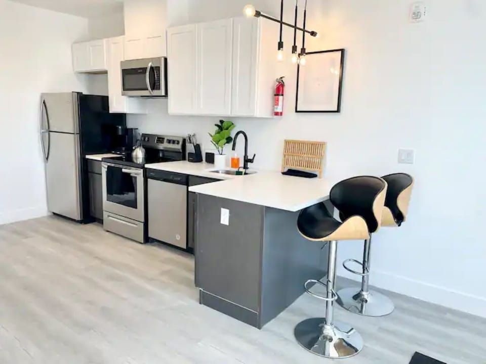 Open-concept kitchen, including breakfast bar and adjustable height stools
