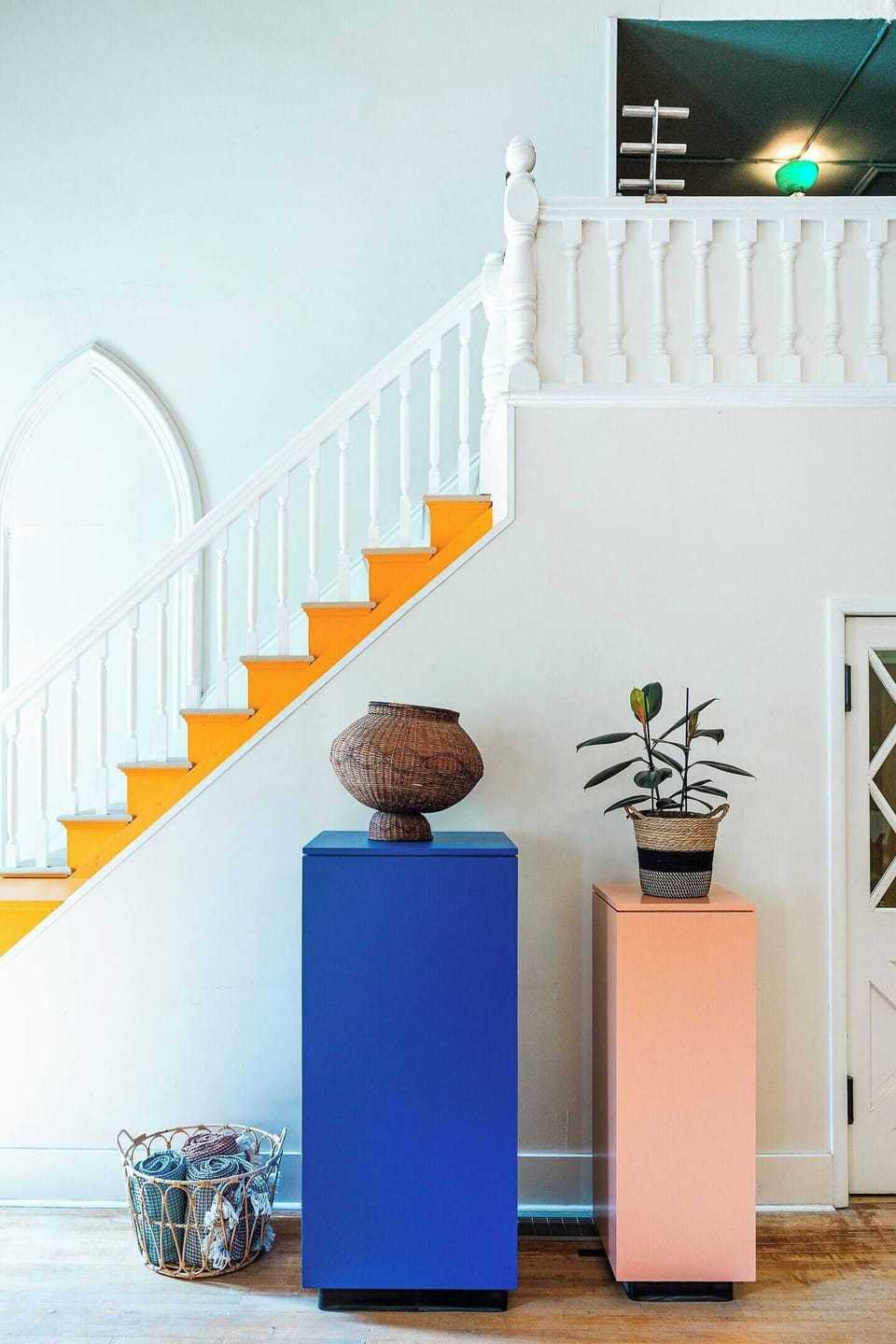 The stairs leading to the second level with a peek into the upstairs sleeping nook.