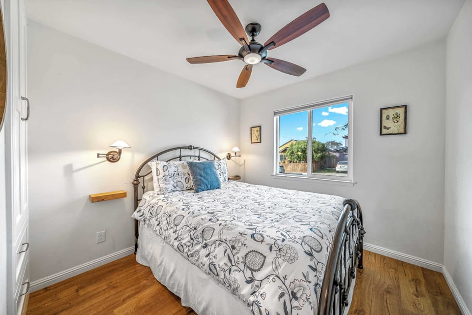 The 2nd of 2 bedrooms, with a plush queen bed & ceiling fan