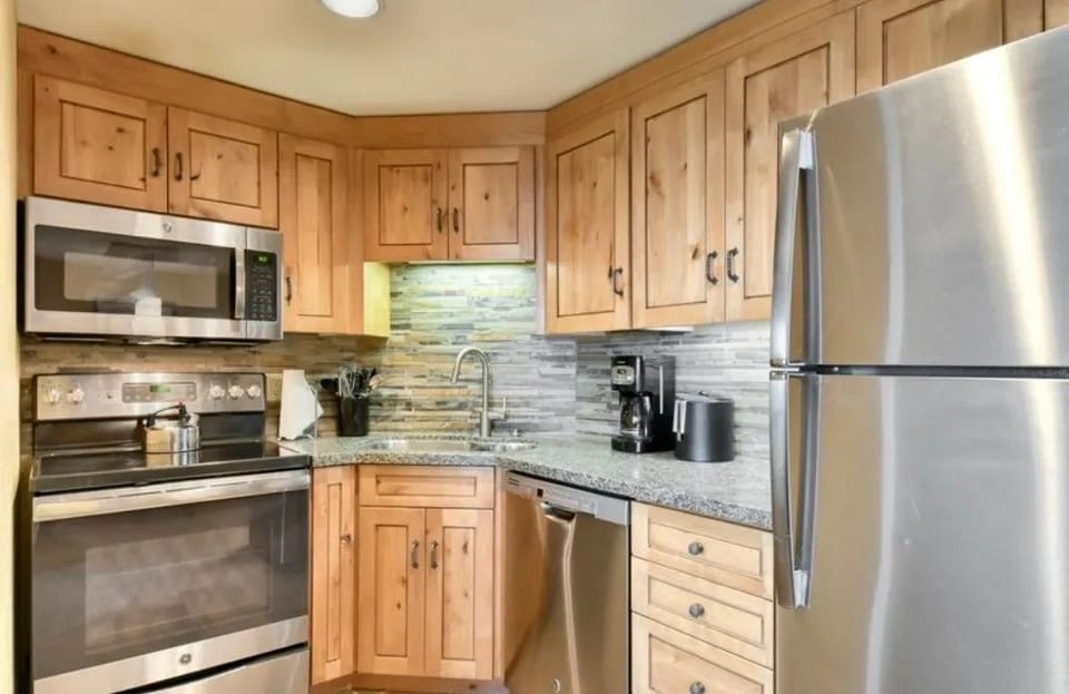 Well-equipped kitchen with stainless steel appliances and wooden cabinets.