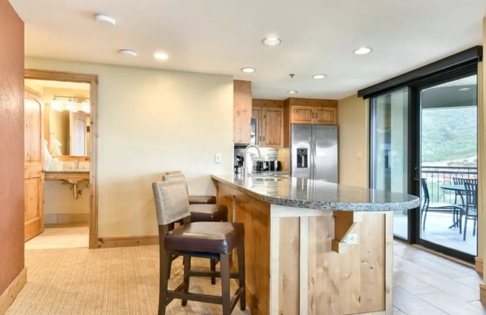 Bright kitchen with a breakfast bar and direct patio access.