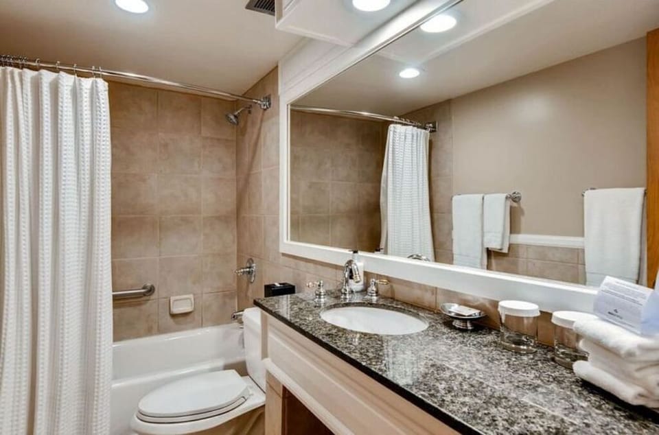 Spacious bathroom with granite countertops and deluxe amenities.
