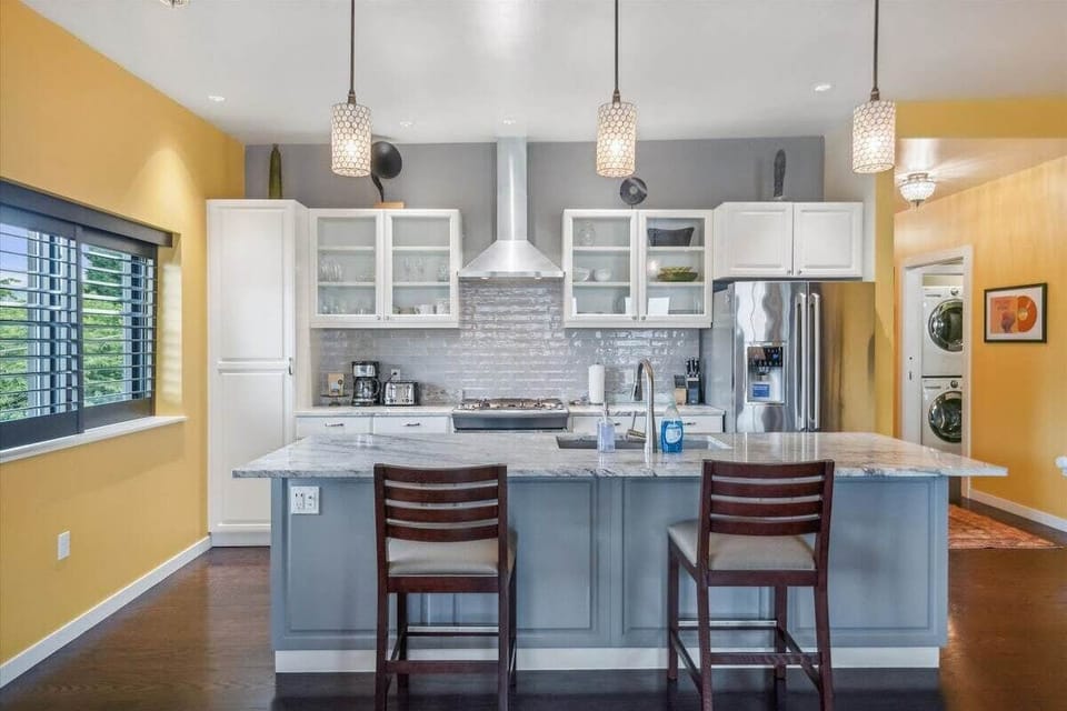Natural light, bar seating, and gas range.