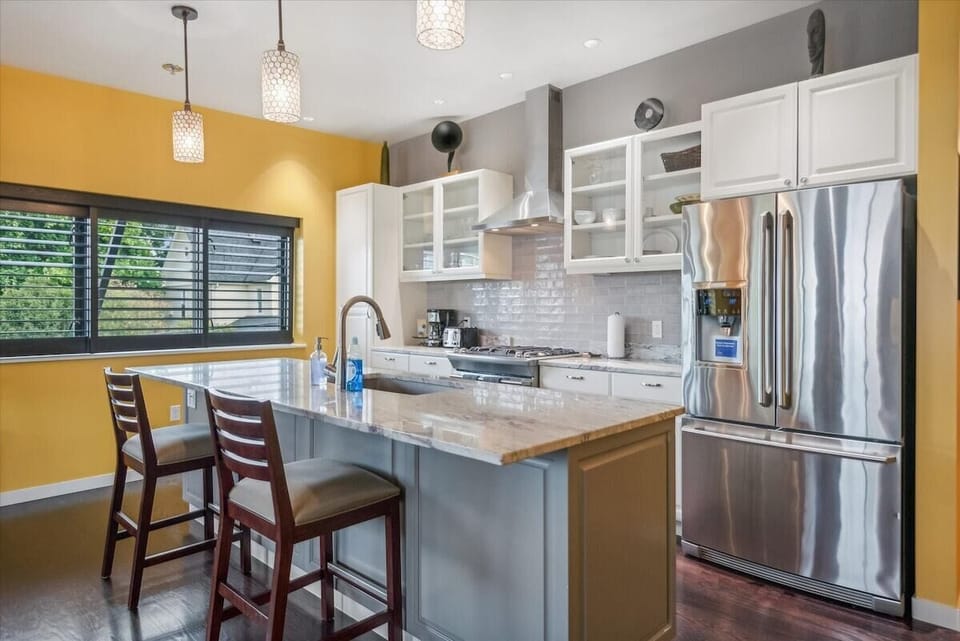 Fully stocked with stainless steel appliances.