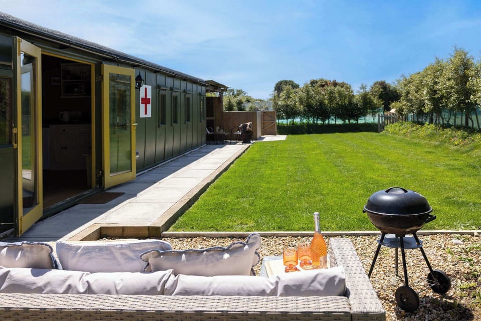 Step into the past with our WW2 ambulance train carriage, complete with cozy outdoor seating. Perfect for a peaceful retreat.