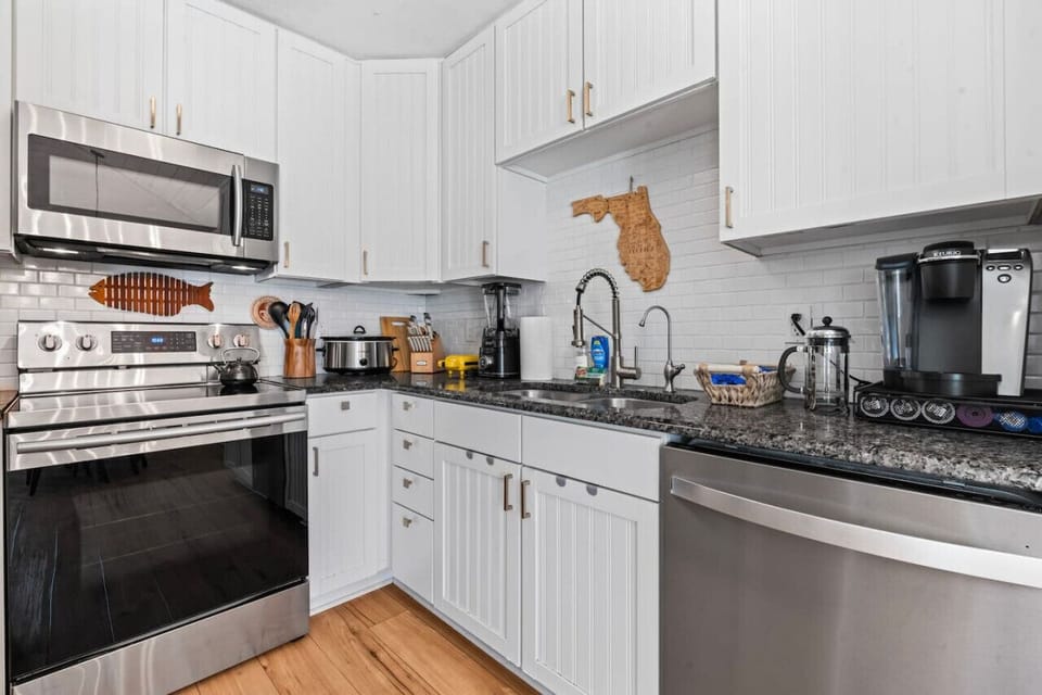 Fully stocked kitchen with cookware and prep space