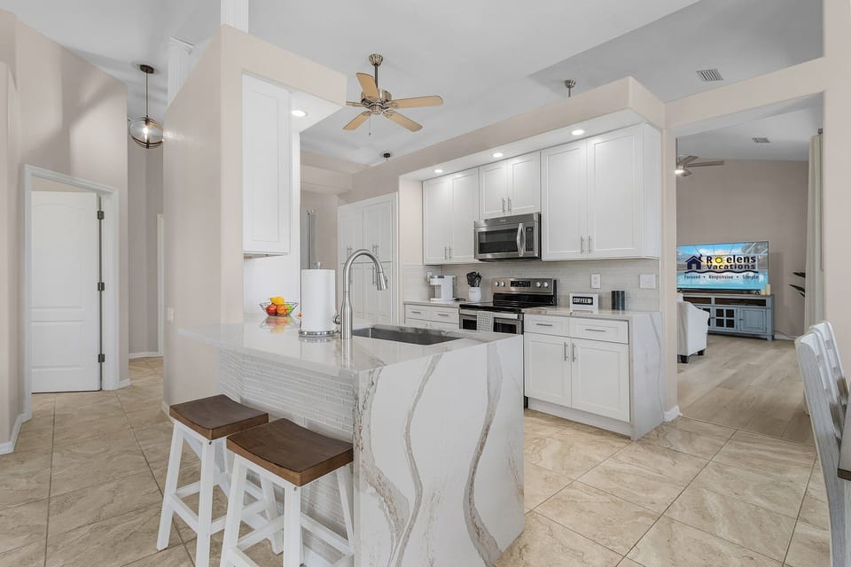breakfast bar and waterfall countertops.