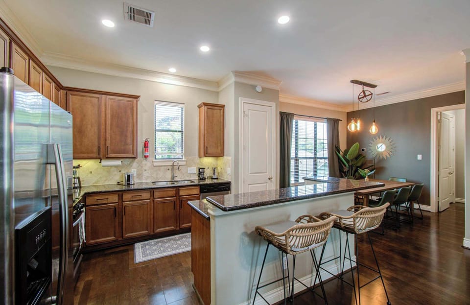 Featuring lovely wood cabinets and dark countertops that bring as much personality to the space as you do, this fully equipped kitchen has everything you need to whip up a tasty meal!
