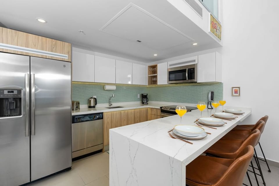 Your modern kitchen awaits, complete with sleek marble countertops, stainless steel appliances, and a breakfast bar where you can enjoy morning coffee or evening cocktails in style.
