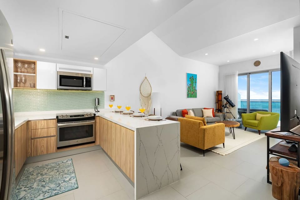 Bright open-concept living with a sleek kitchen, cozy seating, and stunning sea views—your perfect coastal retreat awaits.