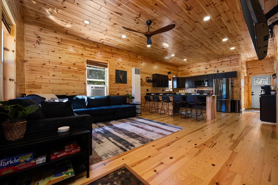 Relax on the plush sectional in our warm, wood-paneled living room.