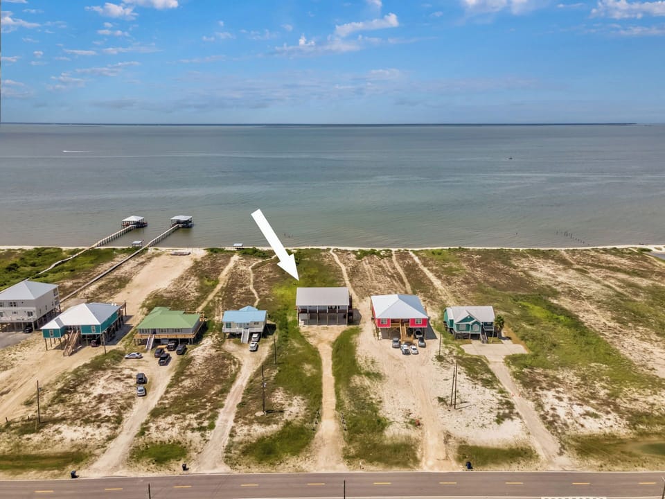Beachfront vacation homes line the pristine coastline with direct access to sandy shores and fishing piers.