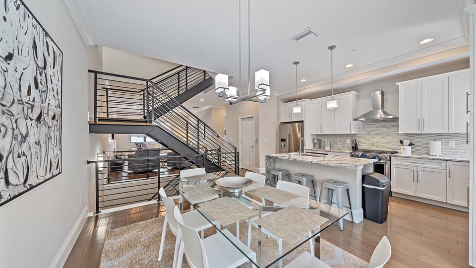 Bright and open coastal-inspired kitchen and dining area with modern finishes, perfect for gathering after a day at Sarasota’s top beaches.