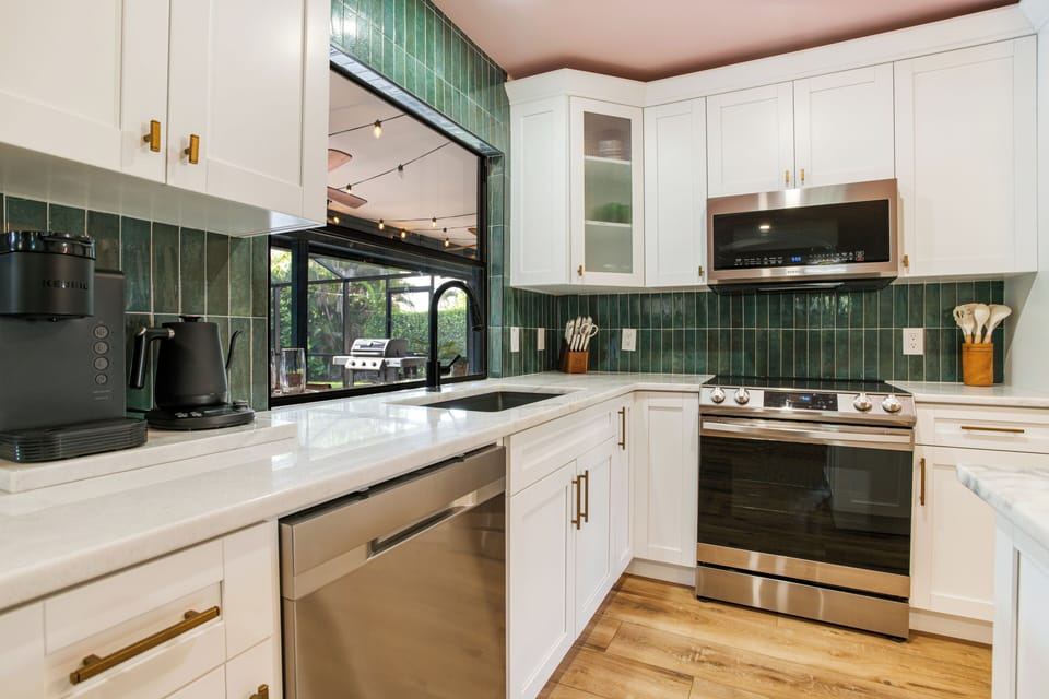 Seamlessly entertain outdoors, the kitchen window transforms into an outside bar