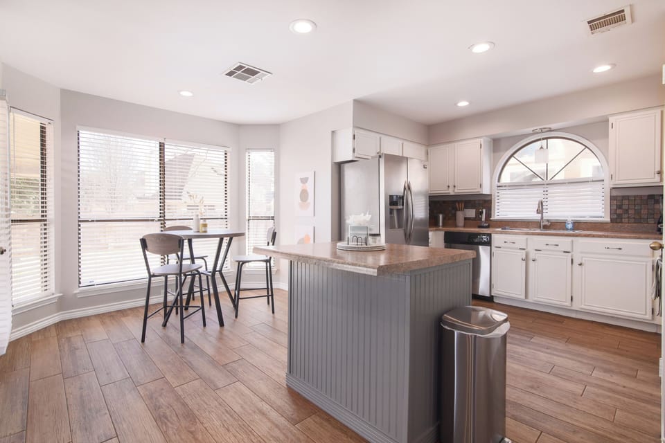 Our kitchen actually features two eating spaces. This is the bistro table that's perfect for a quick breakfast and a coffee in the morning. Enjoy the natural light beaming into the heart of the kitchen.
