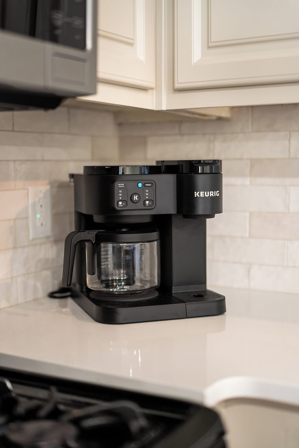 Fully furnished kitchen with views of the lake and coffee maker.