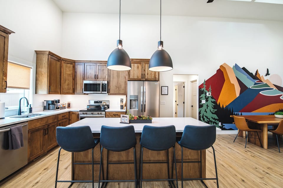 Large island has comfortable counter stools for hanging out in the kitchen.