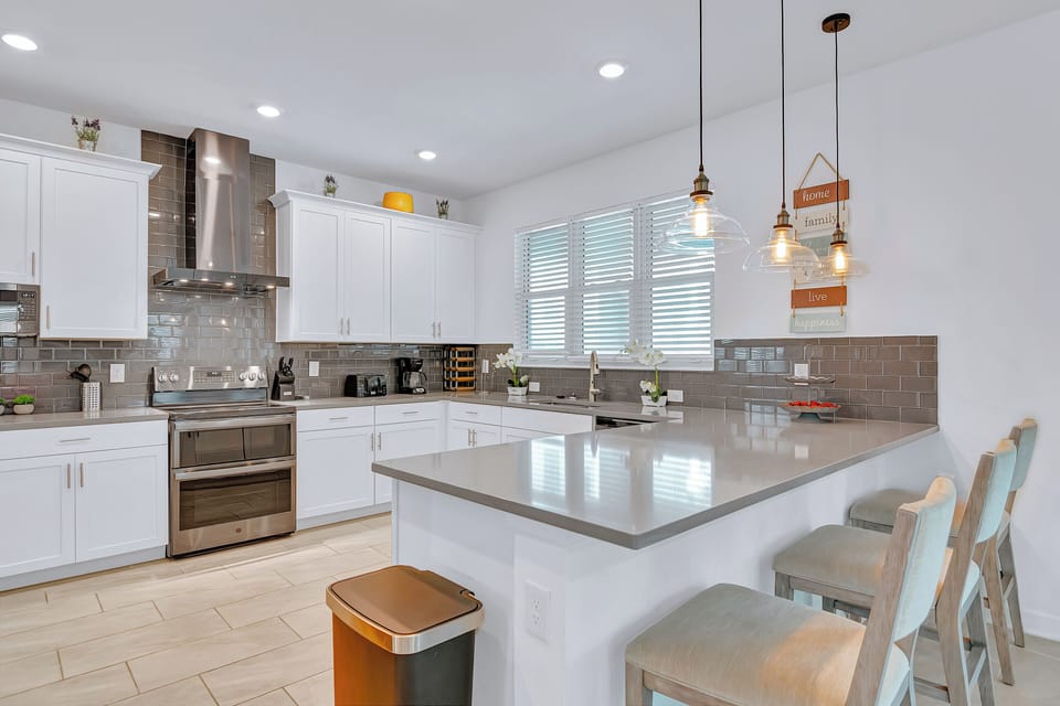 Bright, modern kitchen with sleek finishes, perfect for gathering and cooking.