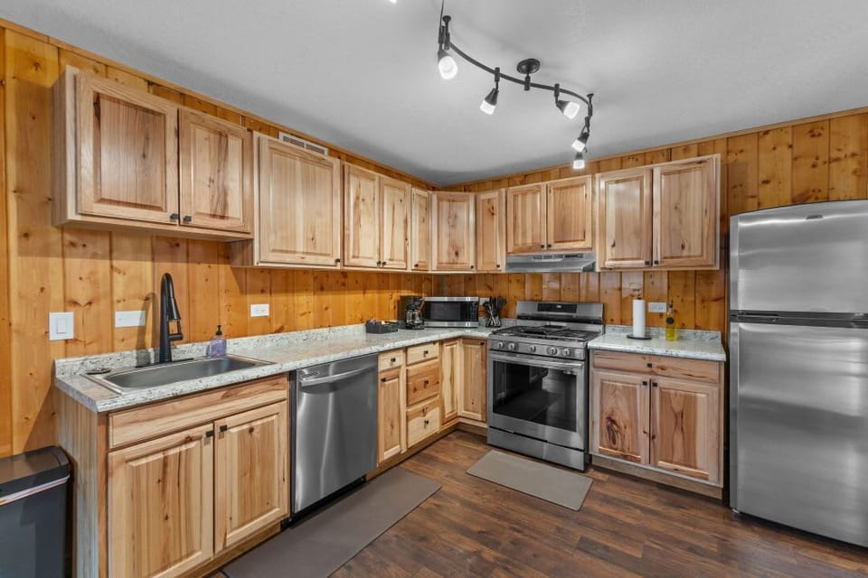 The kitchen has full sized, stainless steel appliances.