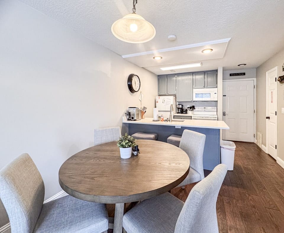 Bright dining area with comfy seating and a fully equipped kitchen, perfect for shared meals.