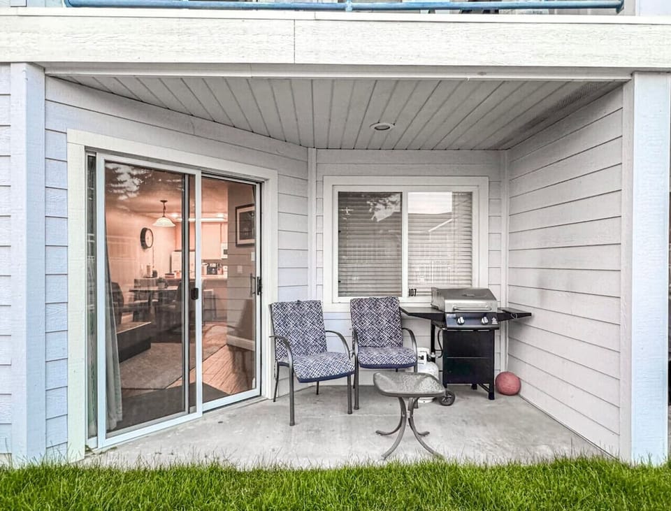 Patio with seating and grill, perfect for relaxing and enjoying outdoor meals together