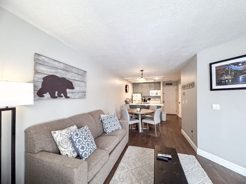 Open-concept living and dining area with charming decor, and inviting natural light