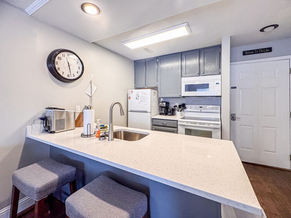 Modern kitchen with bar seating and all essentials, perfect for cooking and casual conversation