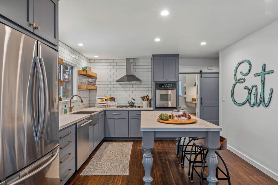 Kitchen is fully equipped and features stainless-steel appliances.