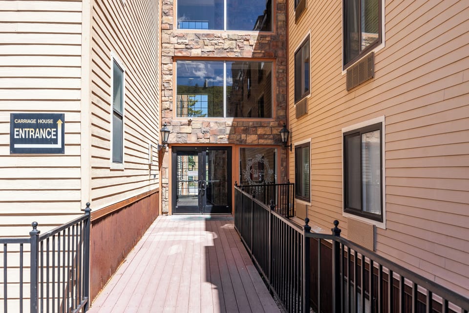 Covered exterior walkway leading to the building entrance, providing convenient and protected access year-round.