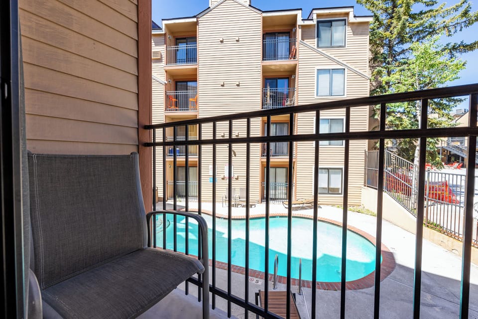 Private balcony overlooking the community pool, offering a pleasant outdoor space to enjoy fresh mountain air and seasonal views.