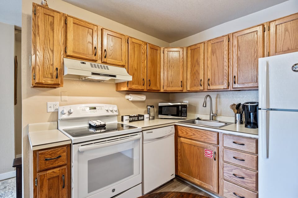 Functional kitchen with full-size appliances, ample cabinet space, and all the essentials needed for preparing meals at home.