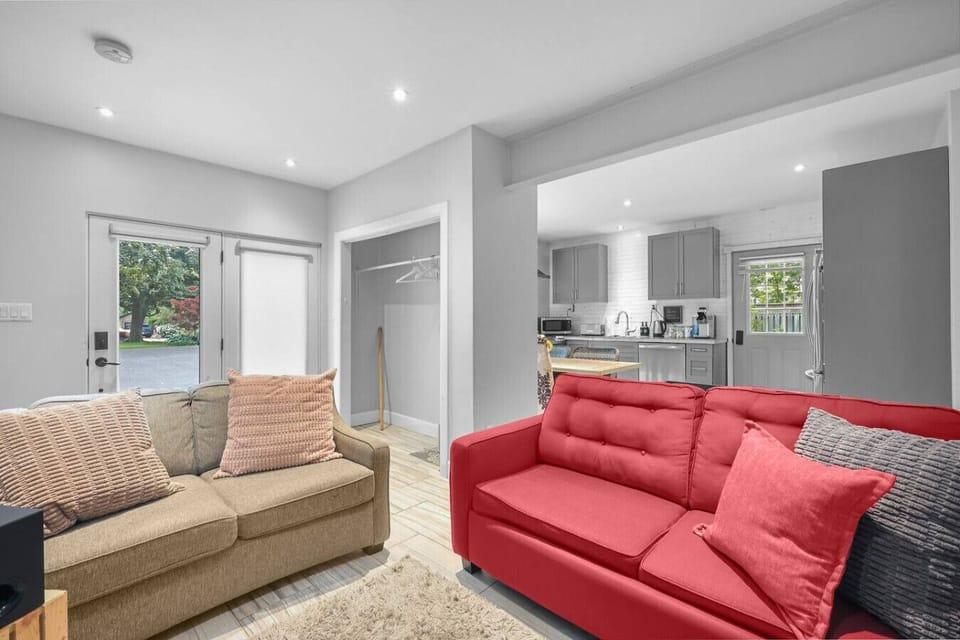 Unwind in the inviting open concept living area, with plush sofas perfect for relaxing. The space flows seamlessly into the kitchen, making it easy to socialize and entertain. It`s the ideal spot for a relaxing stay.