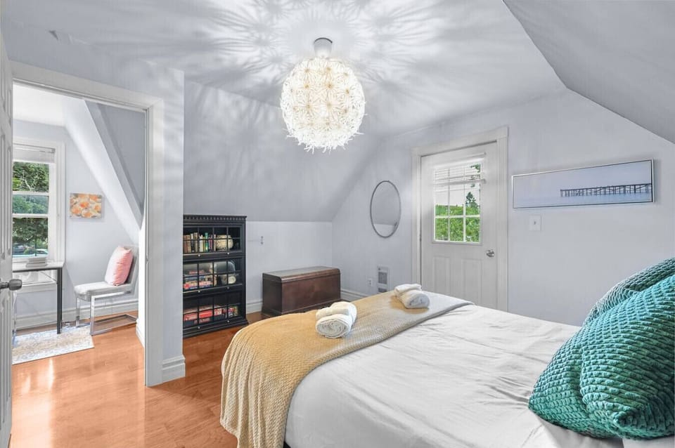 Welcome to your peaceful upstairs retreat. This bright and airy bedroom is perfect for unwinding after a busy day. Relax on the comfortable bed, or step outside onto the deck to enjoy a quiet moment.