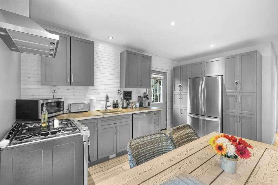Cook with ease and dine in style. Our modern kitchen is fully equipped with everything you need, from a full-sized fridge to a stovetop and oven. Enjoy preparing your meals in a space that`s both beautiful and functional.