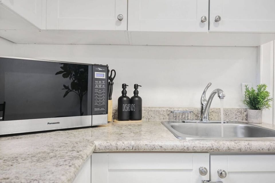 Enjoy the convenience of a well-appointed kitchenette, perfect for preparing quick meals or warming up snacks at your leisure. Featuring a microwave, ample counter space, and all the essentials, it provides the flexibility you need for a comfortable and i