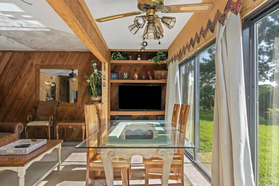 Our beautiful solid wood dining table seating 4 sits right by the windows in the open area right off the living room. 