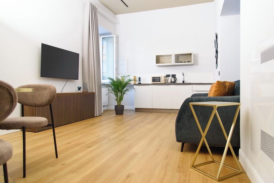 Comfort Apartment | Living area | 36-inch flat-screen TV with digital channels