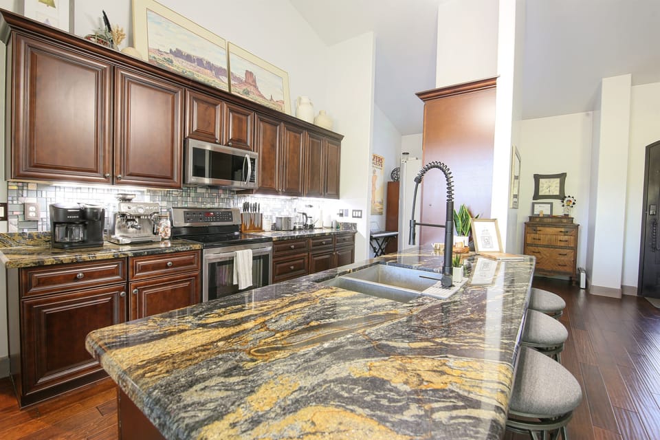 Enjoy open seating at the kitchen peninsula with barstools for 4 and connected to the open living room space