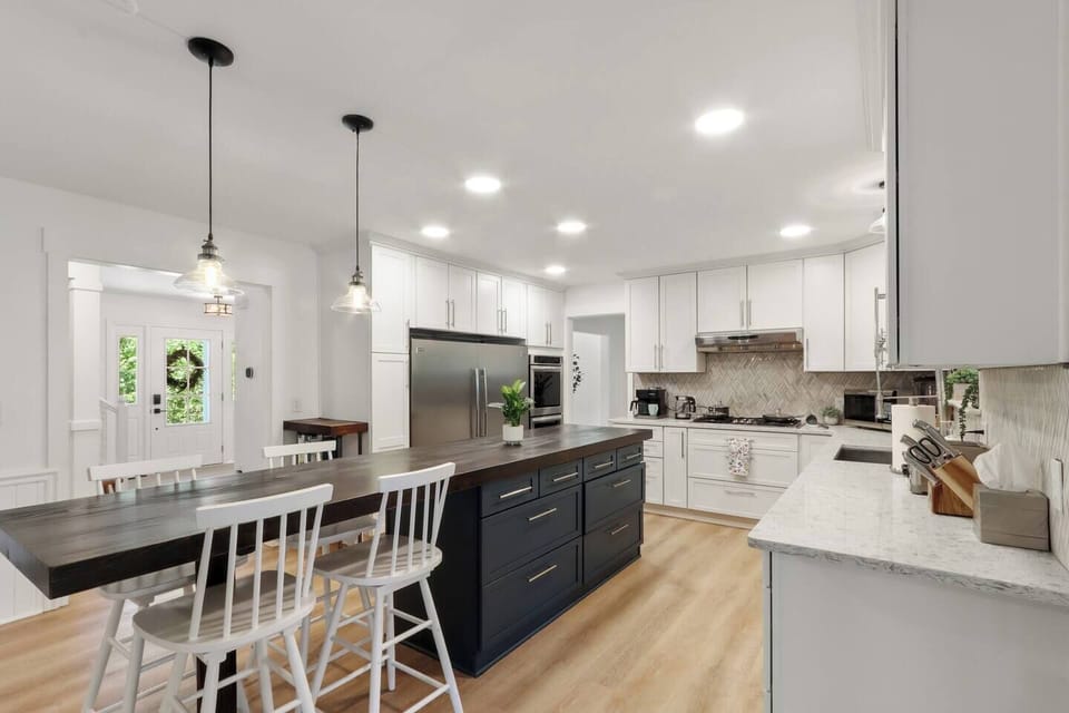 Chef's kitchen includes industrial refrigerator & freezer, double oven, built in 5 burner cook gas cook top, and wide selection of cookware/bakeware