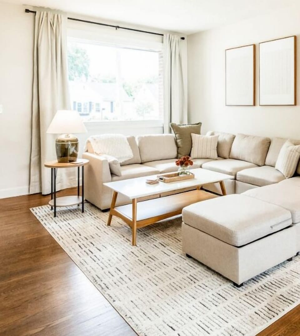 Unwind in the bright and airy living room, featuring a spacious sofa. Enjoy abundant natural light streaming through the windows as you relax and enjoy  the big-screen smart TV. Update: Recliner added for Comfort and Recovery.