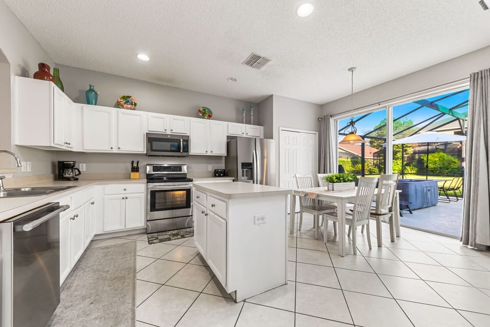 Cook your favorite meals with ease in a sleek kitchen featuring stainless-steel appliances, granite countertops, and all cooking essentials.