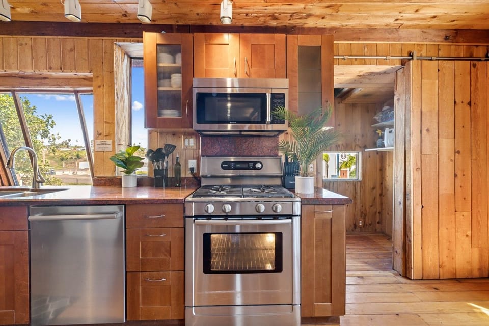 Sleek gas range and microwave, ready for home-cooked meals.