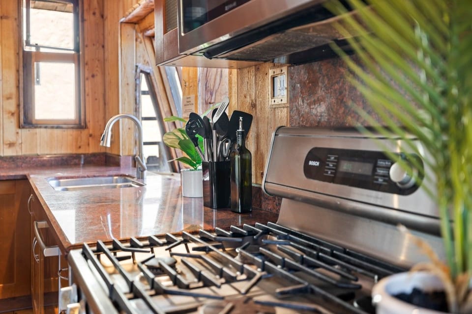 Utensils and prep essentials at the ready beside the gas range.