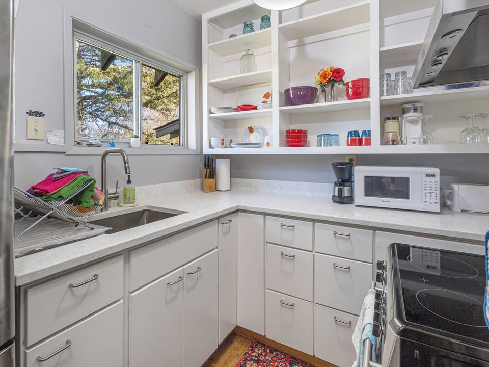 A full kitchen with coffee maker, microwave is provided.