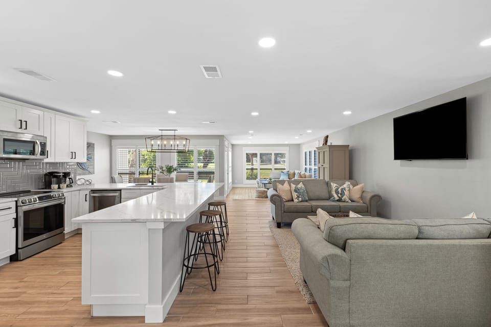 The kitchen island offers additional seating for six, perfect for gathering and entertaining.