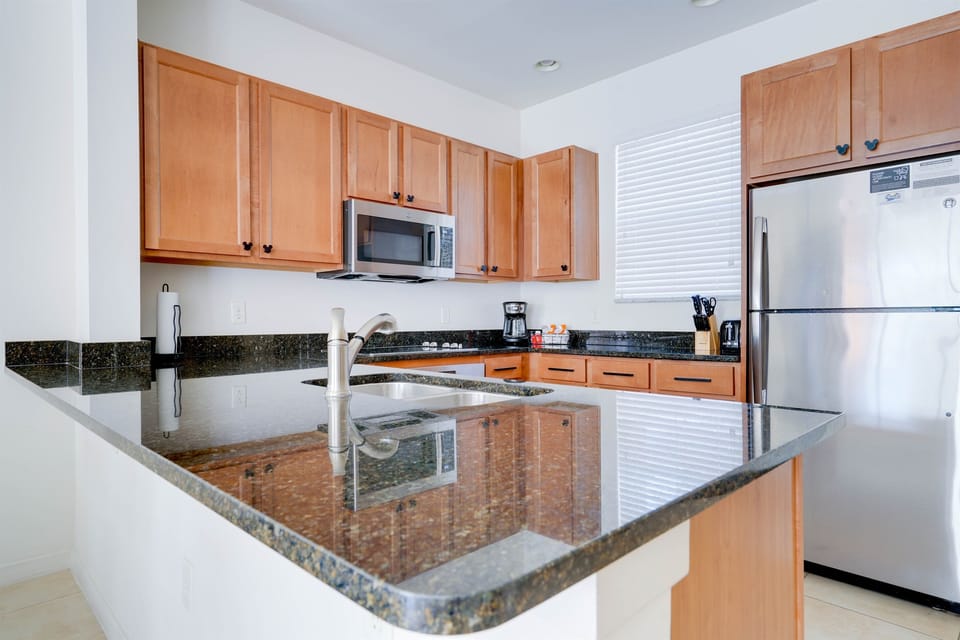 Beautiful kitchen with stainless steel appliances and stone countertops