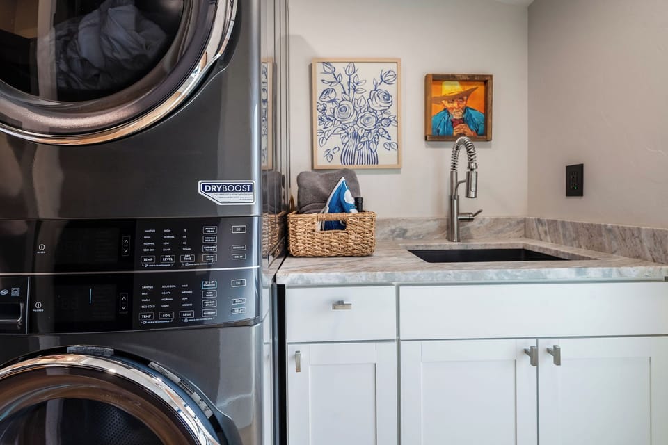The laundry room features amenities to make your stay more convenient and comfortable with laundry essentials such as a sink, detergent, fabric softener, and more. 