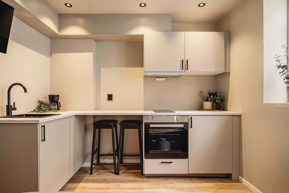 Fully equipped kitchen with modern cabinetry and appliances