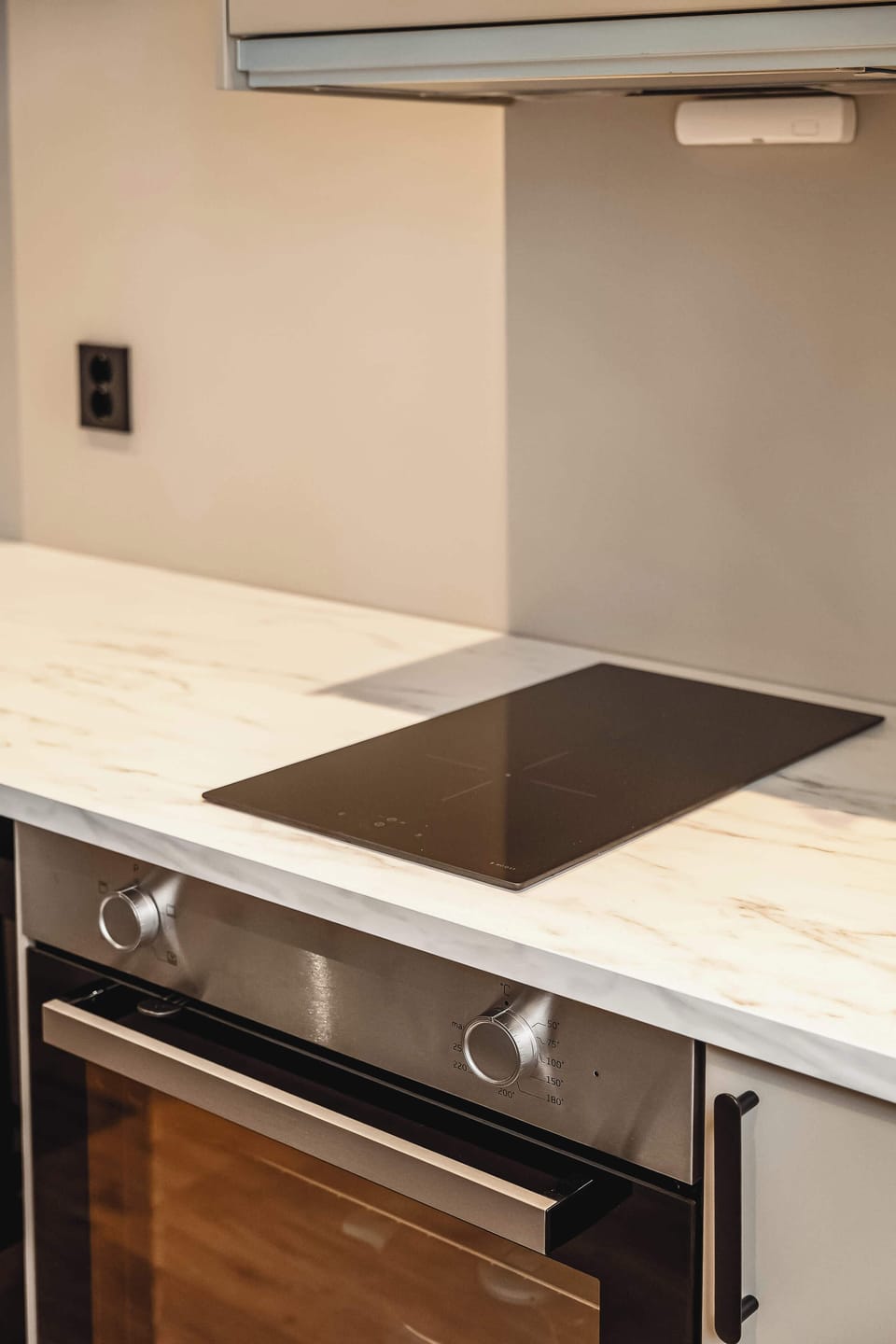 Compact kitchen setup with stovetop and oven essentials